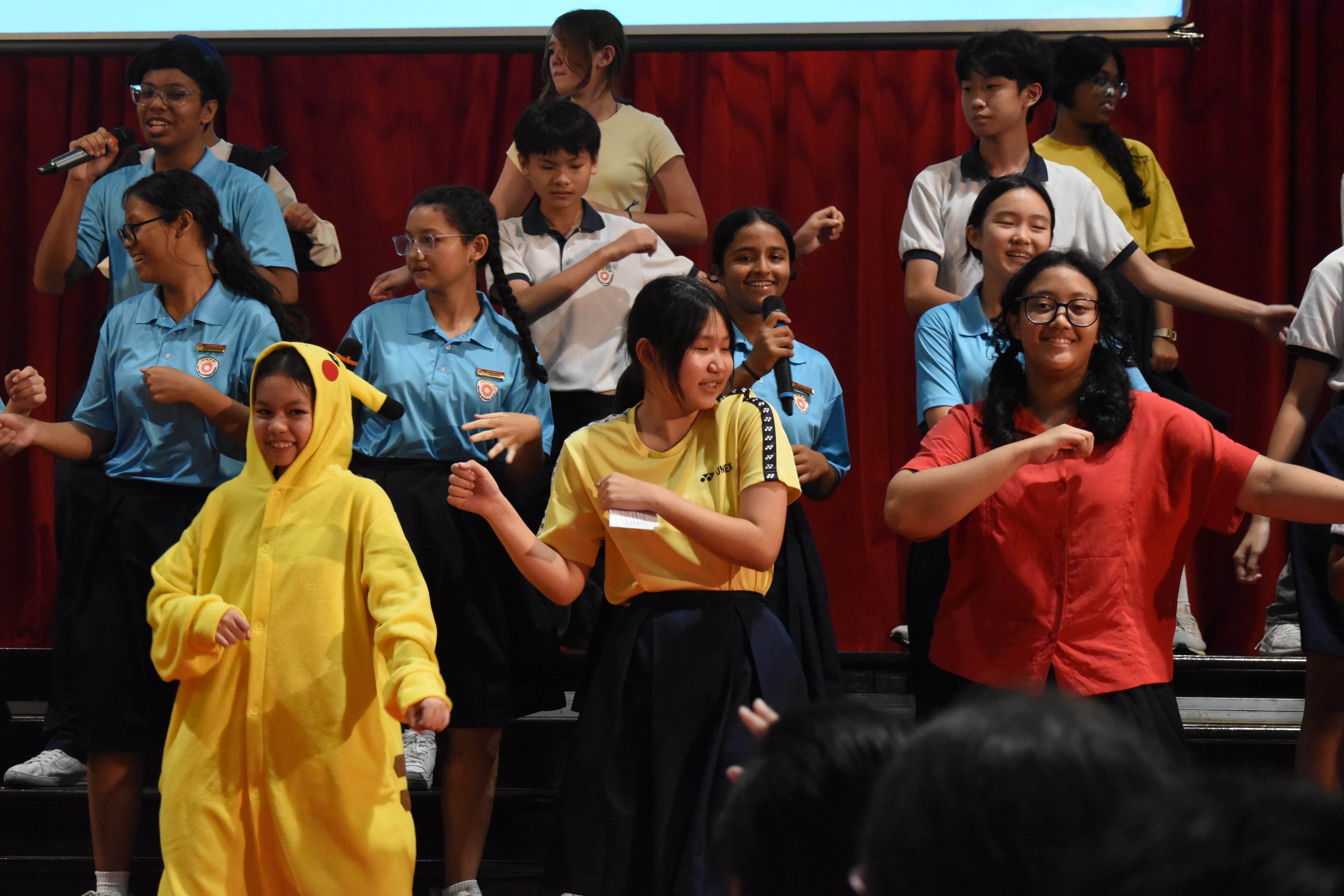 Students dancing on stage for the finale